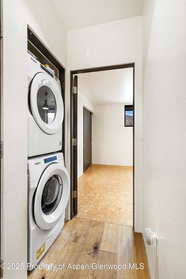 2635 Dolores Way, Carbondale, CO 81623 - clothes washing area with stacked washer / drying machine, laundry area, and wood finished floors