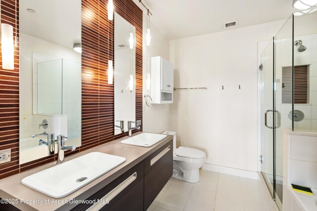 2635 Dolores Way, Carbondale, CO 81623 - bathroom with visible vents, a stall shower, tile patterned flooring, and a sink