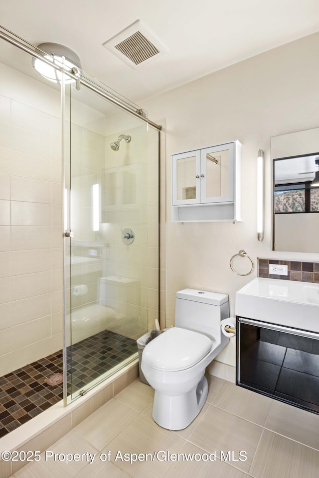 2635 Dolores Way, Carbondale, CO 81623 - bathroom with visible vents, toilet, a shower stall, and vanity