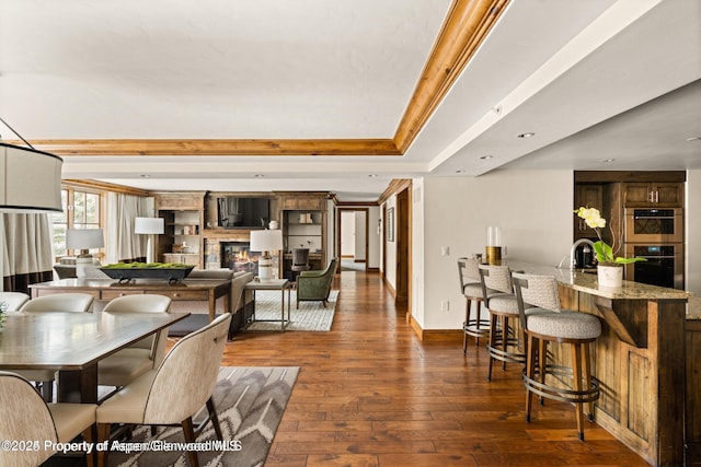 315 E Dean St Unit B30, Aspen, CO 81611 - dining room with dark wood-type flooring, a glass covered fireplace, and bar