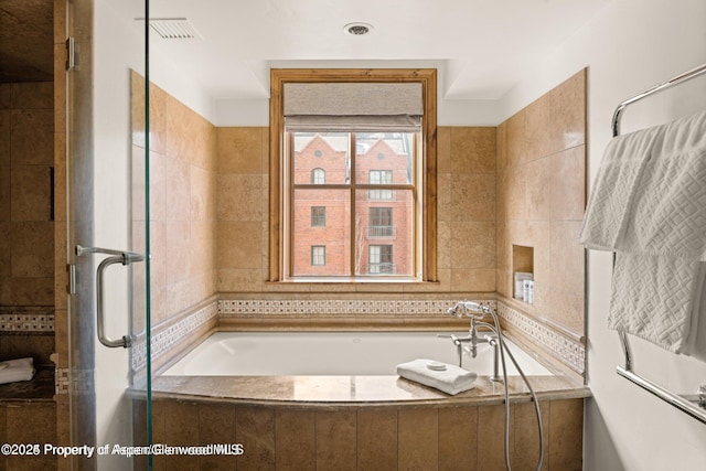 315 E Dean St Unit B30, Aspen, CO 81611 - bathroom featuring a garden tub, a shower stall, and tile walls