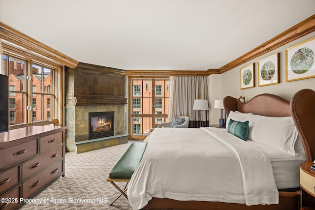 315 E Dean St Unit B30, Aspen, CO 81611 - bedroom with crown molding, a tile fireplace, and multiple windows