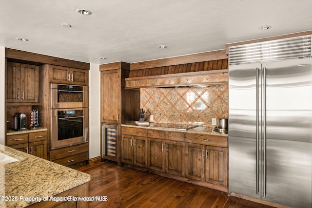 315 E Dean St Unit B30, Aspen, CO 81611 - kitchen featuring stainless steel appliances, wine cooler, dark wood-type flooring, light stone counters, and recessed lighting