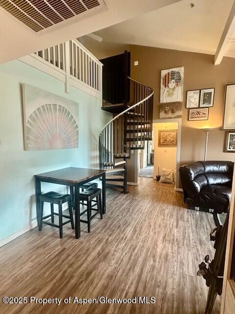 796 Castle Valley Blvd Unit J, New Castle, CO 81647 - living area featuring wood finished floors, stairway, baseboards, and a high ceiling