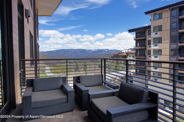 balcony with outdoor lounge area and a mountain view