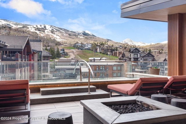 balcony with a mountain view and a fire pit