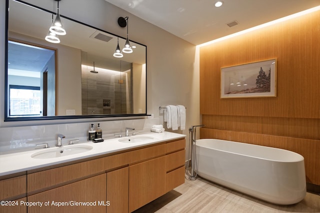 bathroom featuring vanity and shower with separate bathtub