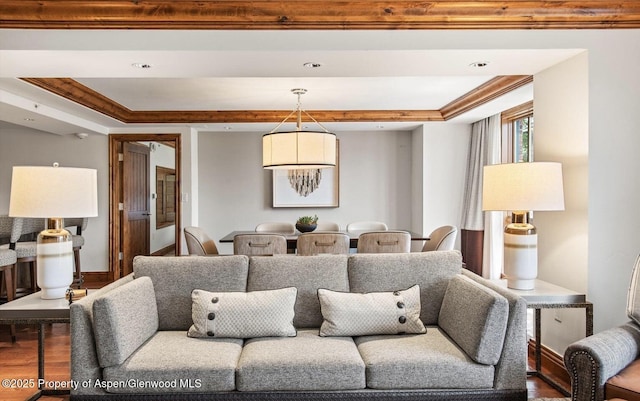 living room featuring hardwood / wood-style floors and crown molding