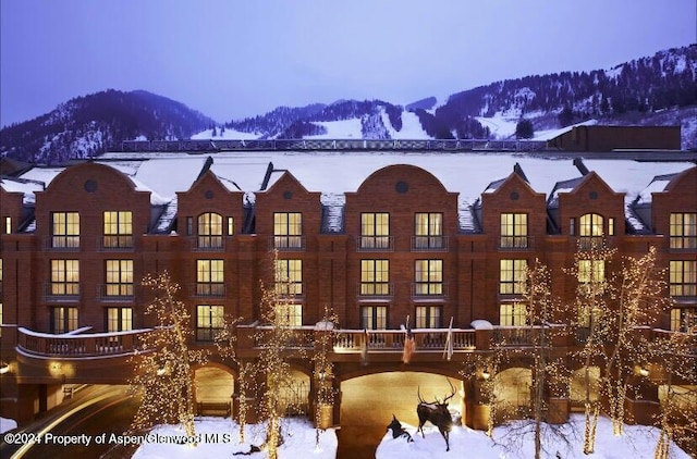 snow covered property with a mountain view