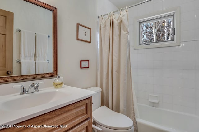 full bathroom featuring vanity, toilet, and shower / bathtub combination with curtain