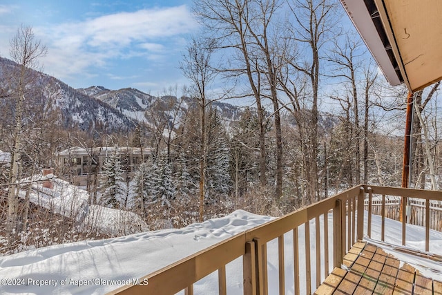 snow covered deck featuring a mountain view