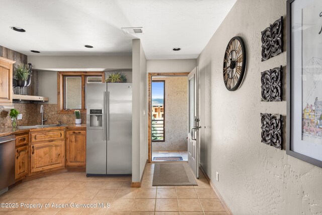 1472 W Main St, Carbondale, CO 81623 - kitchen with stainless steel appliances, light tile patterned flooring, tasteful backsplash, dark countertops, and open shelves