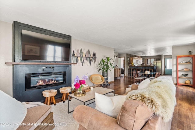 1472 W Main St, Carbondale, CO 81623 - living area featuring a glass covered fireplace and wood finished floors