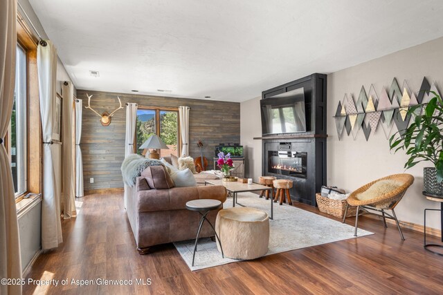 1472 W Main St, Carbondale, CO 81623 - living area with a glass covered fireplace, wood finished floors, and wooden walls