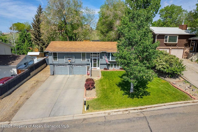 836 Ledford St, Craig, CO 81625 - split foyer home with driveway, an attached garage, a front lawn, and a porch