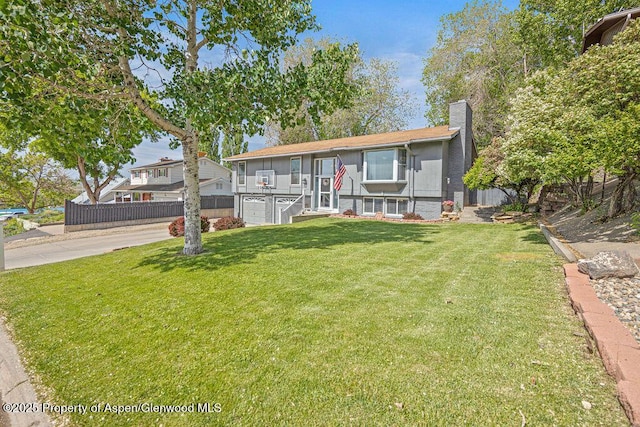 836 Ledford St, Craig, CO 81625 - view of front facade featuring a chimney, concrete driveway, and a garage