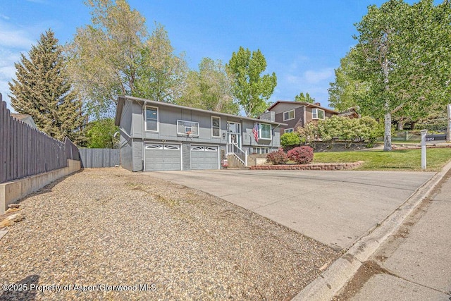836 Ledford St, Craig, CO 81625 - view of front of property with an attached garage, concrete driveway, and stairs
