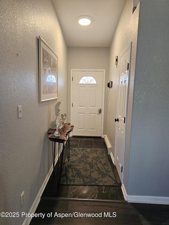1650 Dogwood Dr, Rifle, CO 81650 - doorway with a textured wall and baseboards