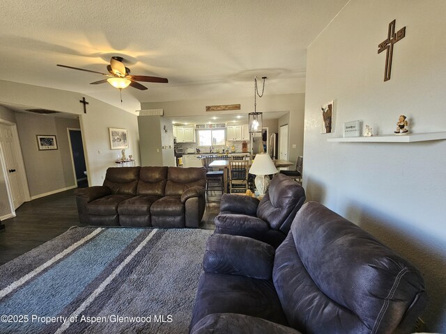 1650 Dogwood Dr, Rifle, CO 81650 - living room featuring a ceiling fan, dark wood-style floors, and baseboards