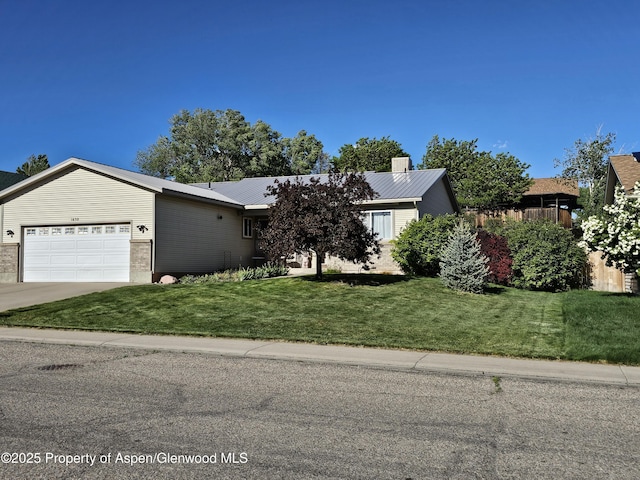 1650 Dogwood Dr, Rifle, CO 81650 - ranch-style house with an attached garage, driveway, a front lawn, and metal roof