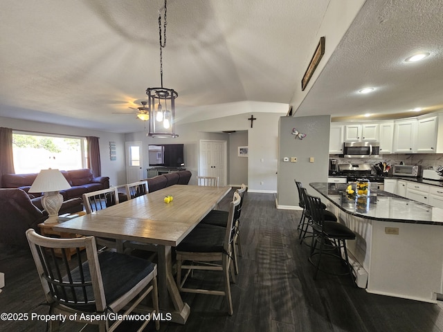 1650 Dogwood Dr, Rifle, CO 81650 - dining room featuring dark wood finished floors, baseboards, ceiling fan, a textured ceiling, and lofted ceiling
