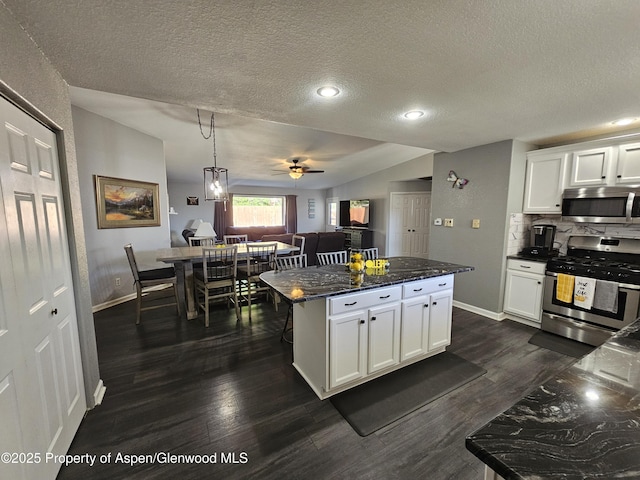 1650 Dogwood Dr, Rifle, CO 81650 - kitchen with stainless steel appliances, a textured ceiling, backsplash, white cabinets, and baseboards