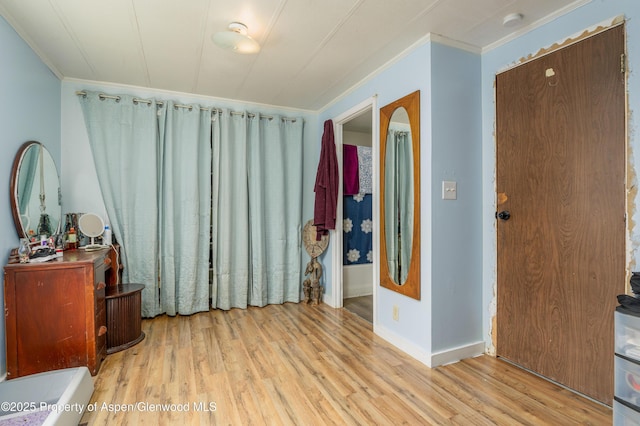 265 SW 11th Ave, Cedaredge, CO 81413 - bedroom with ornamental molding, light wood-style flooring, and baseboards