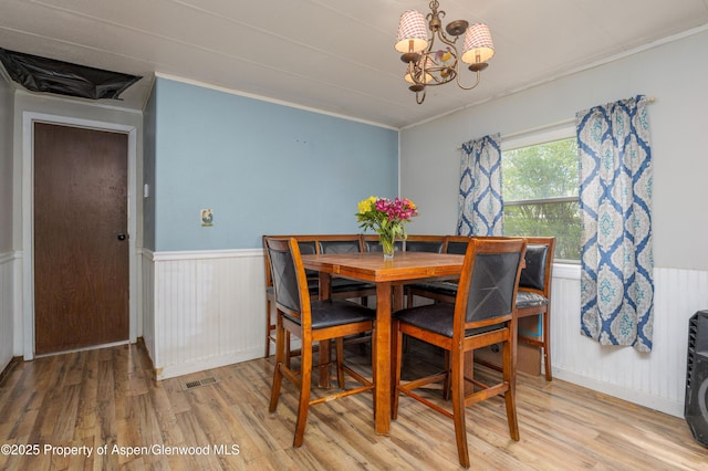 265 SW 11th Ave, Cedaredge, CO 81413 - dining space with a chandelier, light wood finished floors, wainscoting, and crown molding