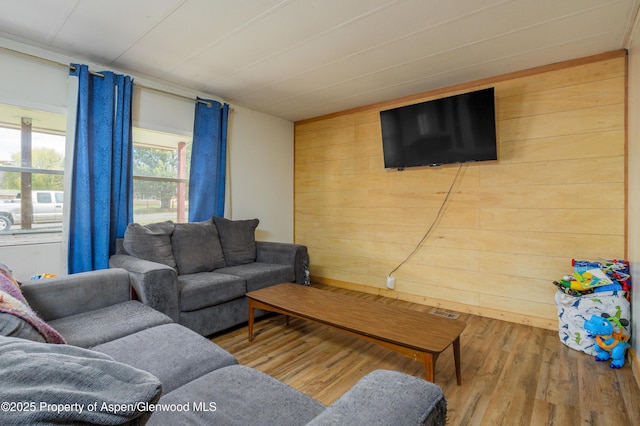 265 SW 11th Ave, Cedaredge, CO 81413 - living room featuring wood finished floors and wood walls