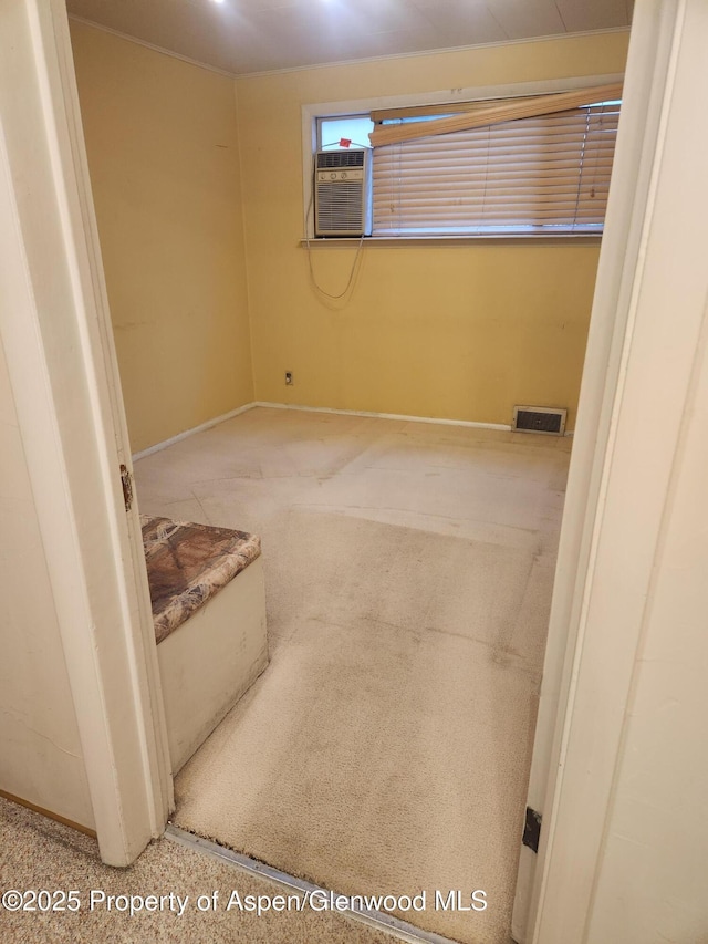 spare room featuring cooling unit and baseboards