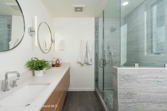 bathroom with a shower with door and vanity