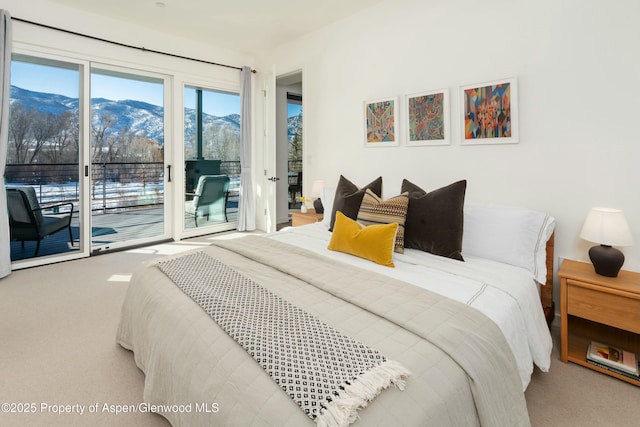 bedroom featuring a mountain view, access to outside, and carpet