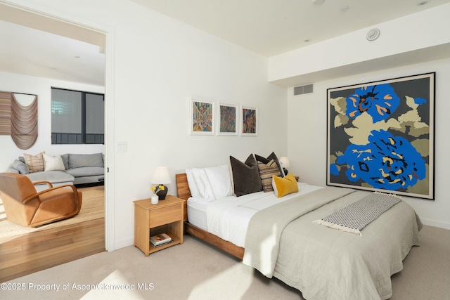 bedroom with light colored carpet