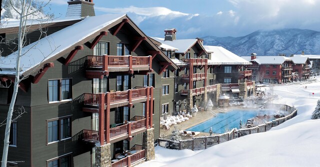 snow covered building with a mountain view