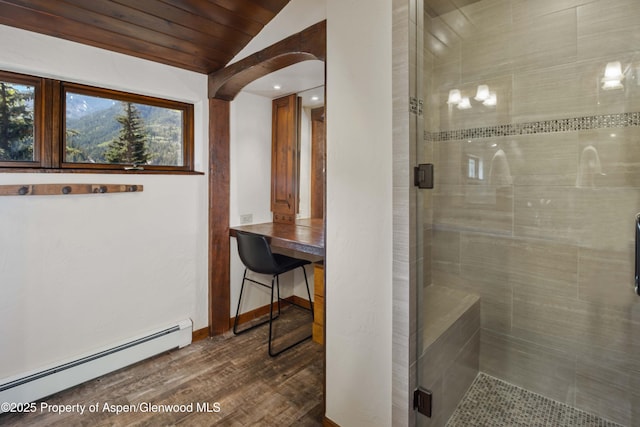 425 Crystal Park Dr, Redstone, CO 81623 - full bath with a baseboard radiator, vaulted ceiling, a shower stall, wood finished floors, and baseboards
