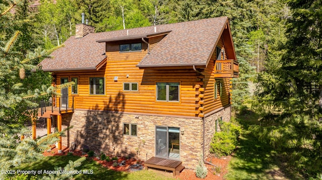 425 Crystal Park Dr, Redstone, CO 81623 - rear view of property featuring stone siding, a balcony, a chimney, log exterior, and roof with shingles