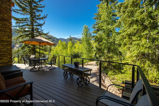 425 Crystal Park Dr, Redstone, CO 81623 - wooden terrace featuring outdoor dining space and a mountain view