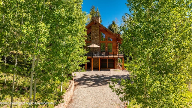 425 Crystal Park Dr, Redstone, CO 81623 - view of side of property with log siding, a deck, and a chimney