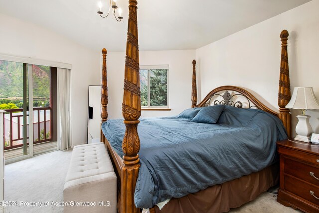 bedroom featuring lofted ceiling, access to exterior, light colored carpet, and multiple windows