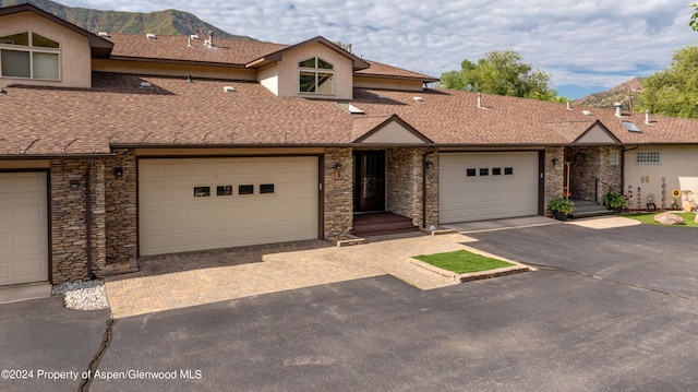 view of property with a mountain view and a garage