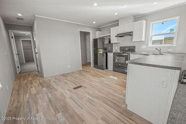 kitchen with visible vents, freestanding refrigerator, under cabinet range hood, black / electric stove, and light wood finished floors