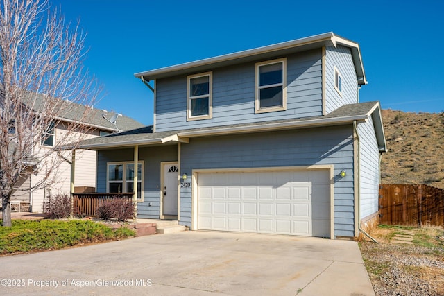 2420 Pioneer Way, Rifle, CO 81650 - traditional-style home featuring concrete driveway, fence, and an attached garage