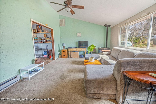carpeted living room with a textured ceiling, a ceiling fan, visible vents, vaulted ceiling, and a textured wall