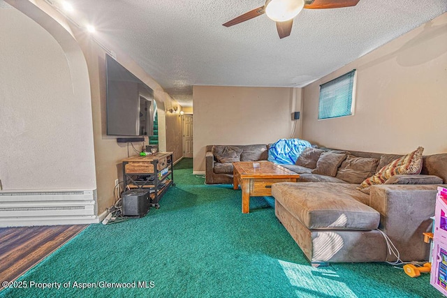 living room featuring a textured ceiling and ceiling fan