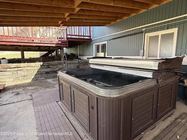 view of patio with a deck and a hot tub
