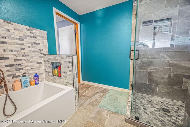 full bath with baseboards, a garden tub, and a stall shower