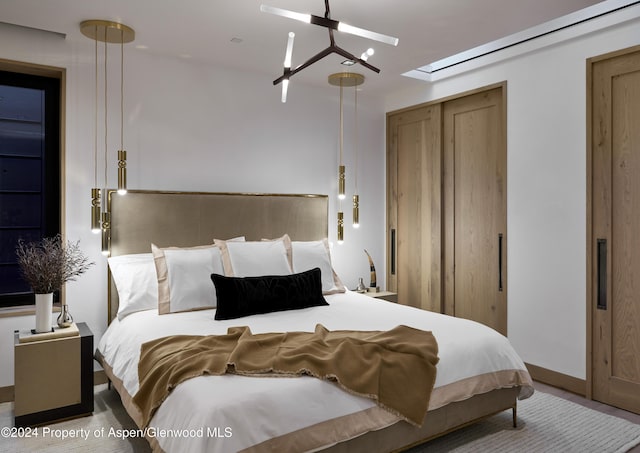 bedroom with ceiling fan with notable chandelier