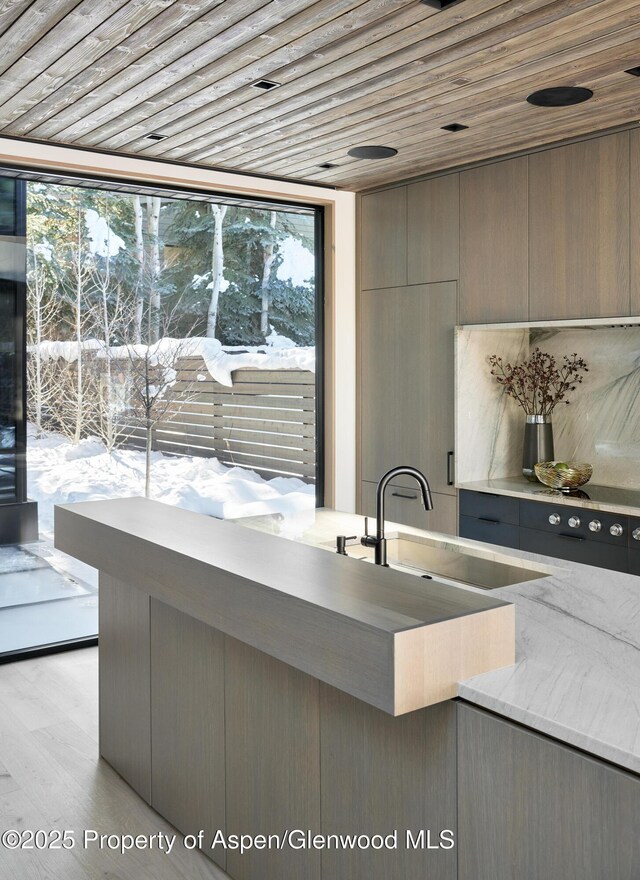 dining area featuring light hardwood / wood-style floors and wood ceiling