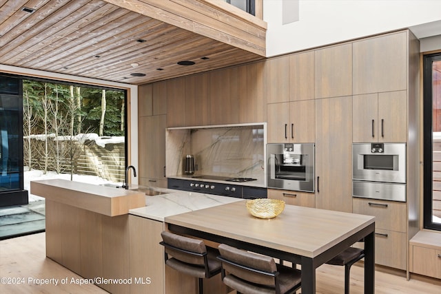 kitchen featuring wall oven, wood ceiling, sink, black gas cooktop, and light hardwood / wood-style flooring