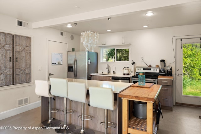 2240 Old Herron Rd, Basalt, CO 81621 - kitchen featuring appliances with stainless steel finishes, a breakfast bar area, light countertops, finished concrete floors, and recessed lighting
